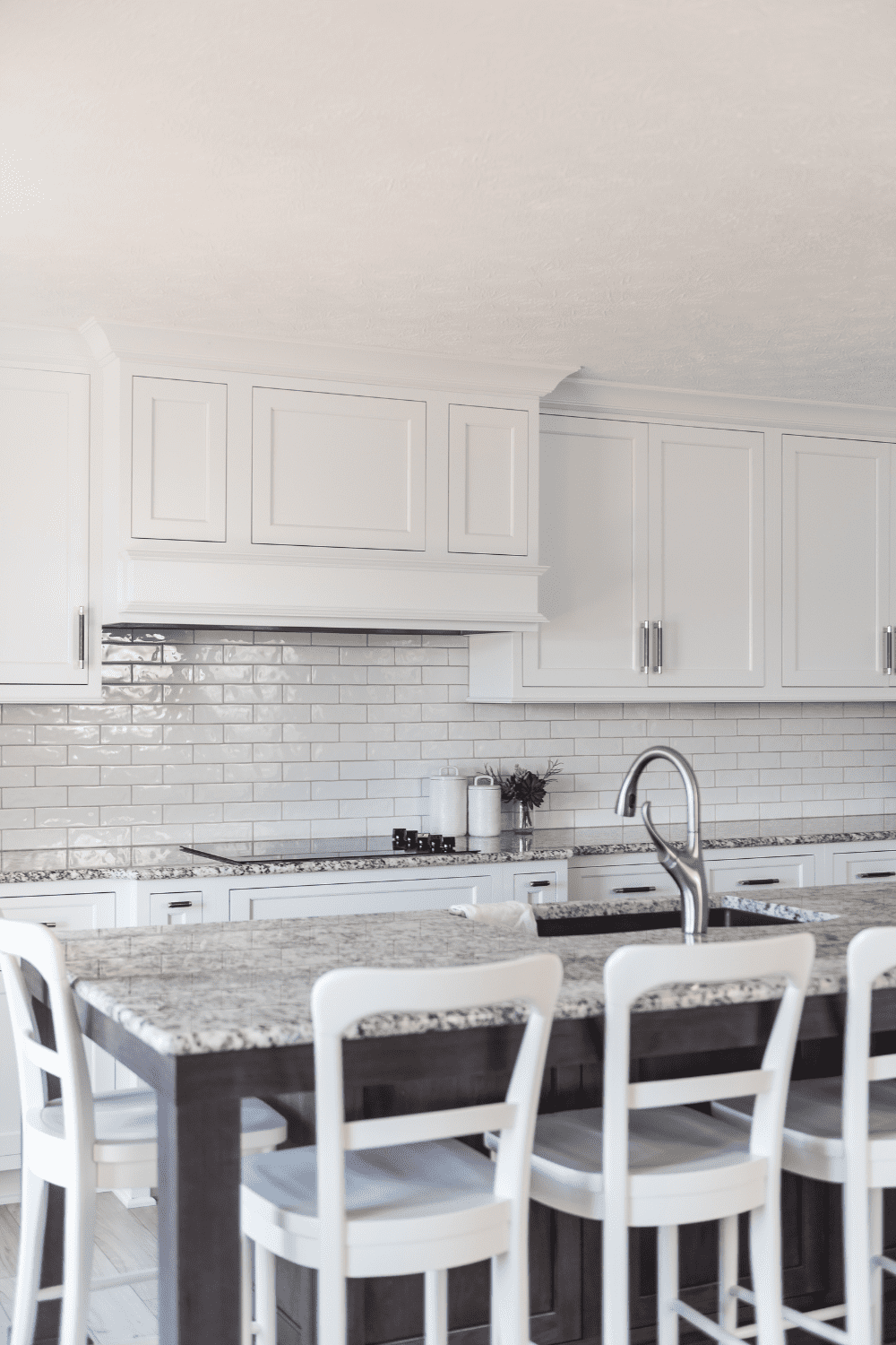 Nicholas Design Build | A kitchen with white cabinets and white counter tops.
