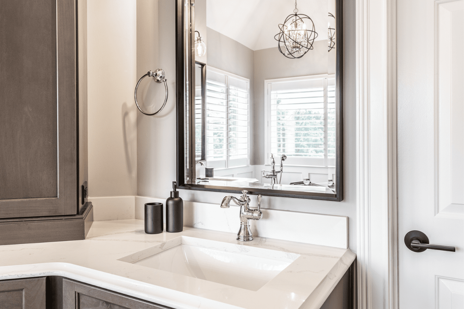 Nicholas Design Build | A master bath remodel with a sink and a mirror.