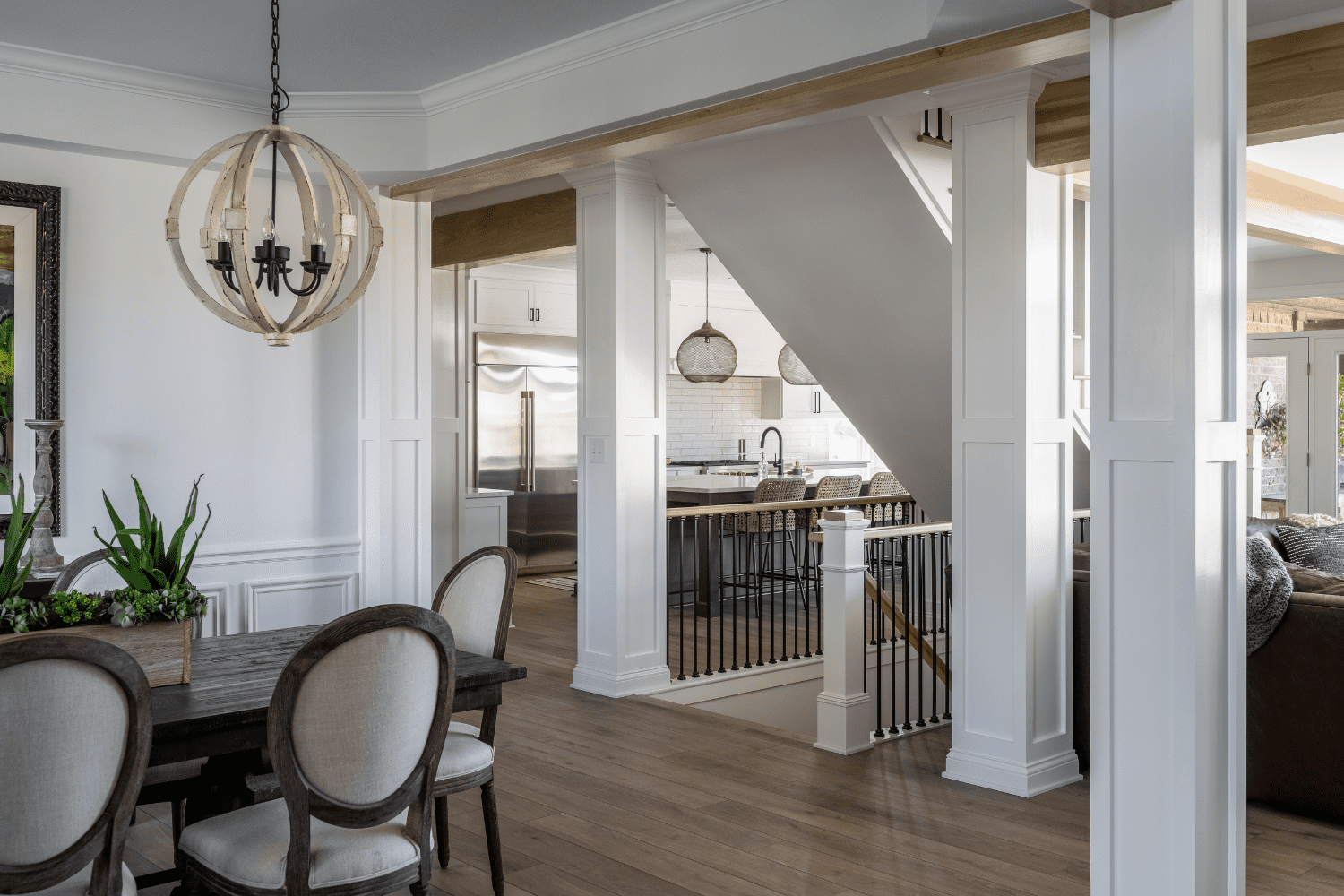 Nicholas Design Build | A dining room with hardwood floors and a staircase.