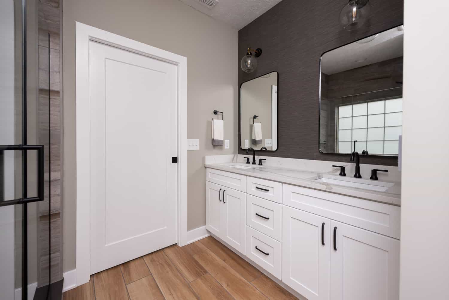 Nicholas Design Build | A modern bathroom with wood floors.