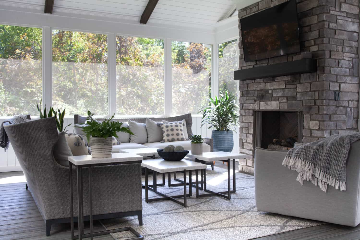 Nicholas Design Build | An outdoor living room with a fireplace and tv.