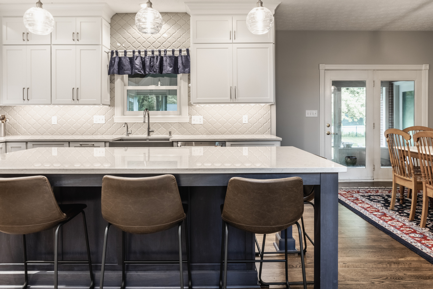 Nicholas Design Build | A kitchen with a center island and bar stools.