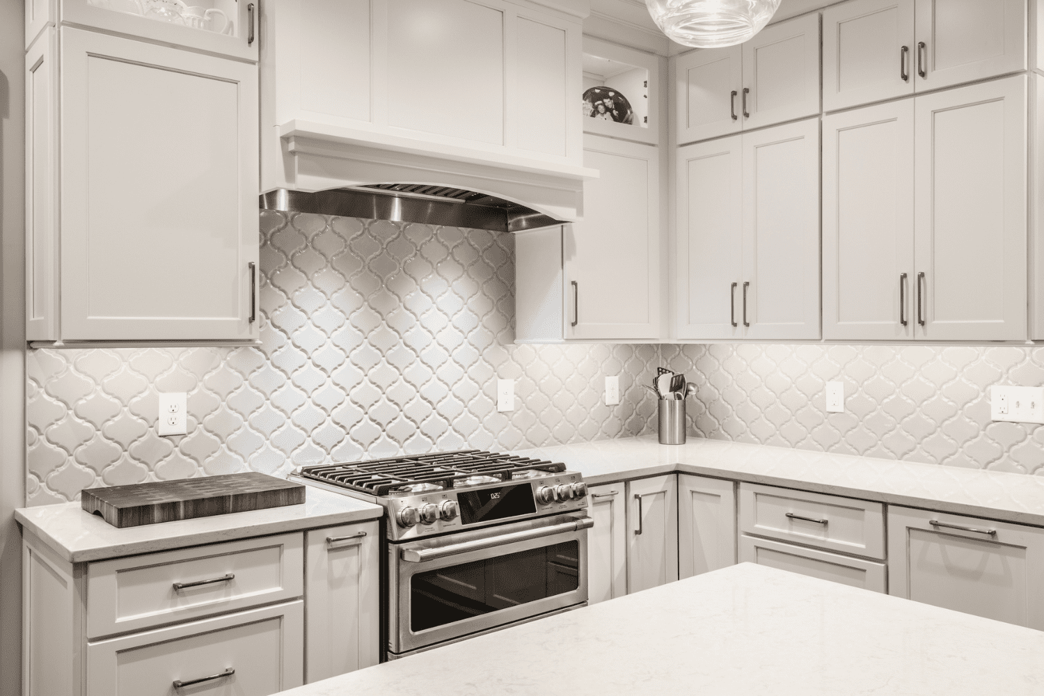Nicholas Design Build | A kitchen with white cabinets and stainless steel appliances.