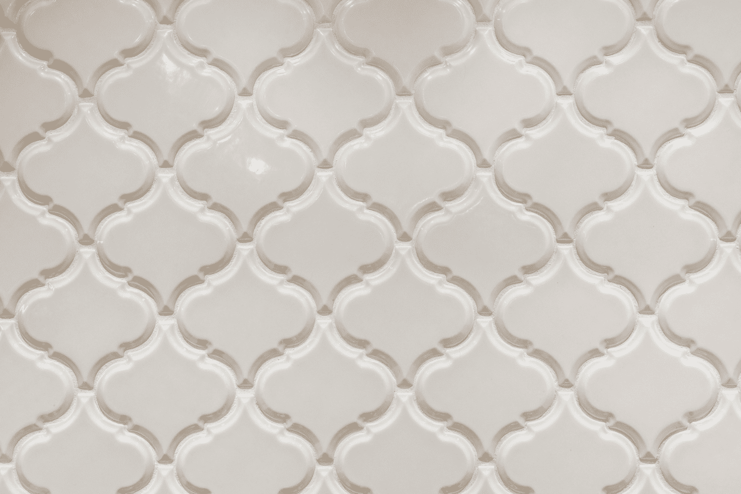 Nicholas Design Build | A close up of a white tile with a pattern on it.