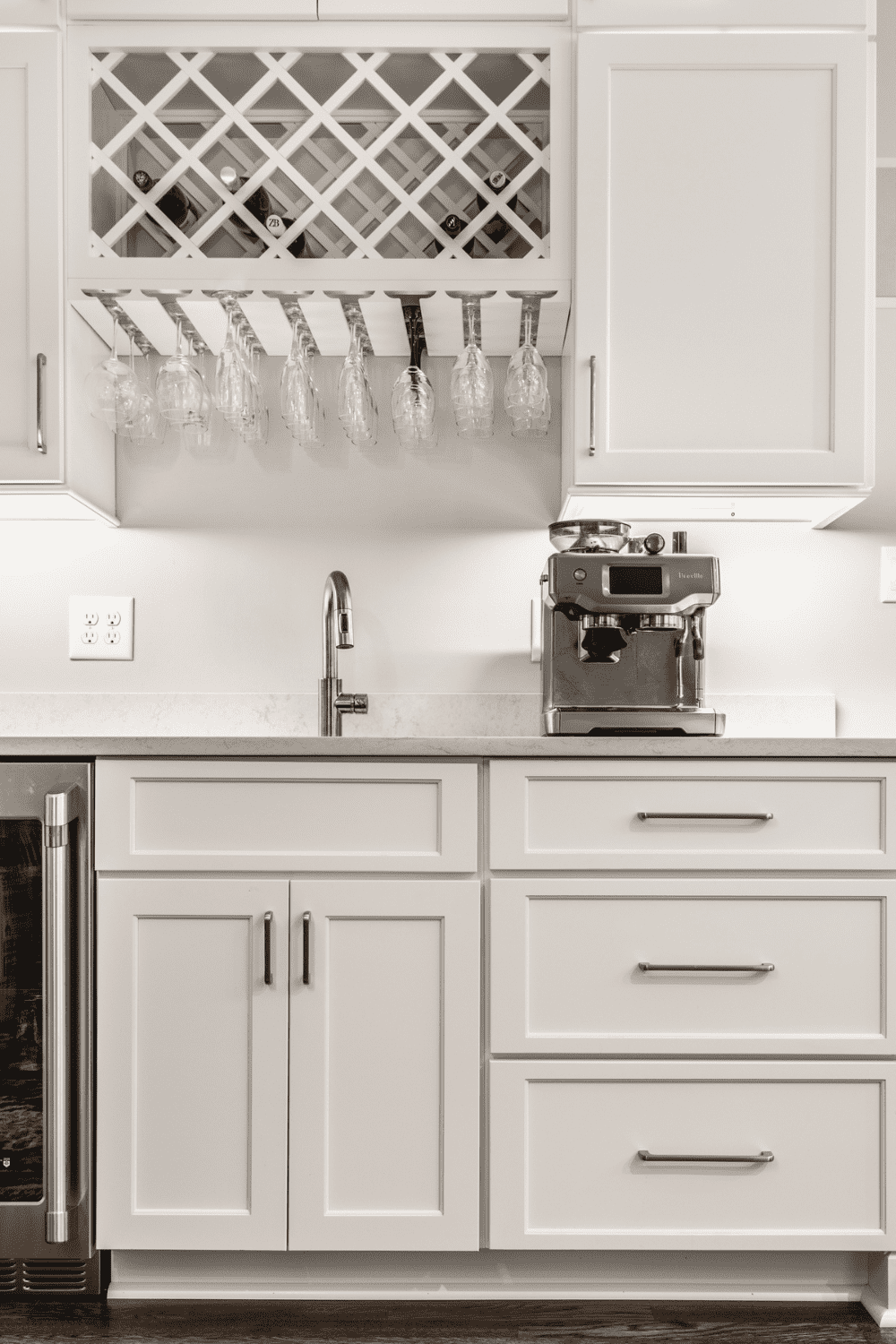 Nicholas Design Build | A kitchen with white cabinets and a wine rack.