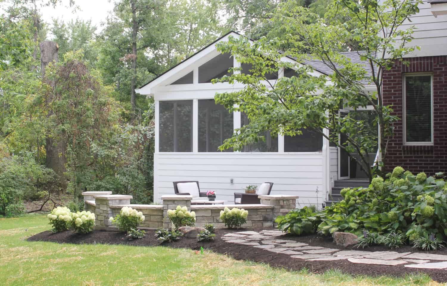Nicholas Design Build | A backyard with a patio and landscaping.
