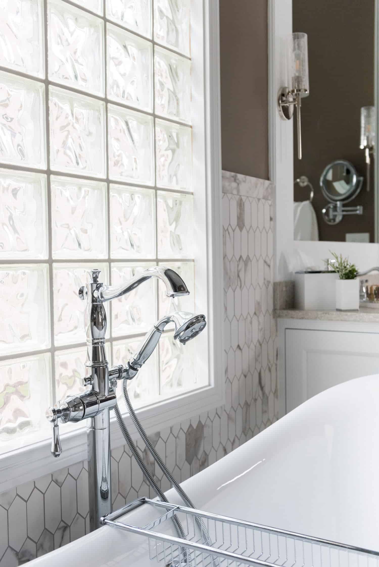 Nicholas Design Build | An oasis-like white bathroom with a bathtub and a window.