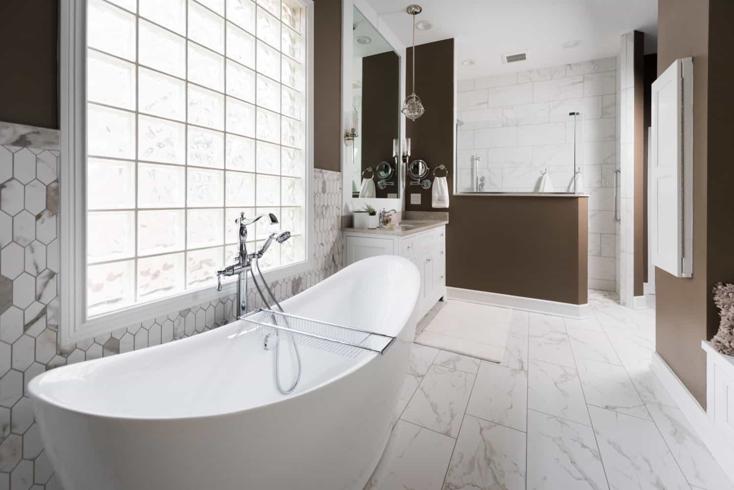 Nicholas Design Build | An oasis-like bathroom with a white tub.