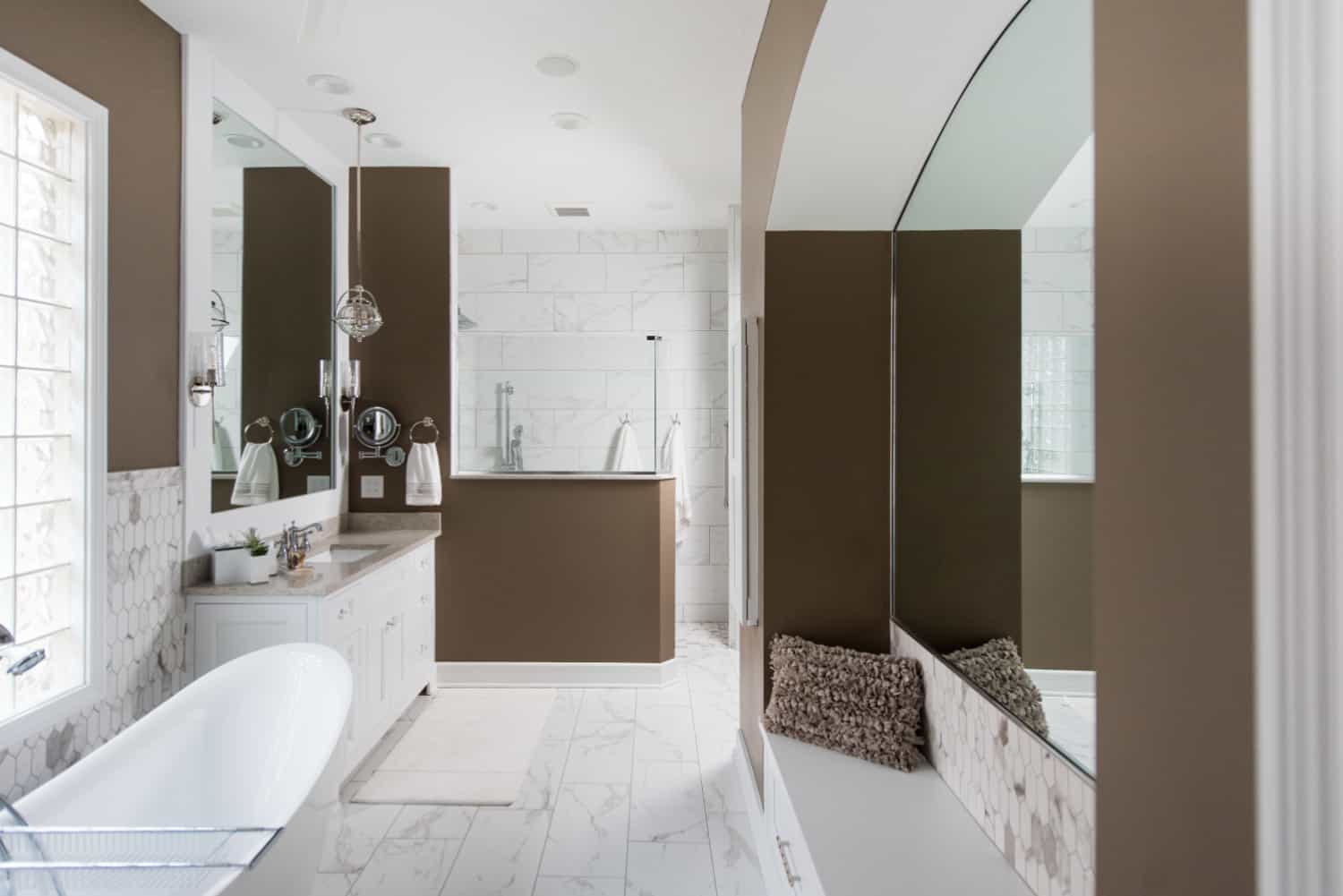 Nicholas Design Build | A bathroom oasis with brown walls and a white tub.