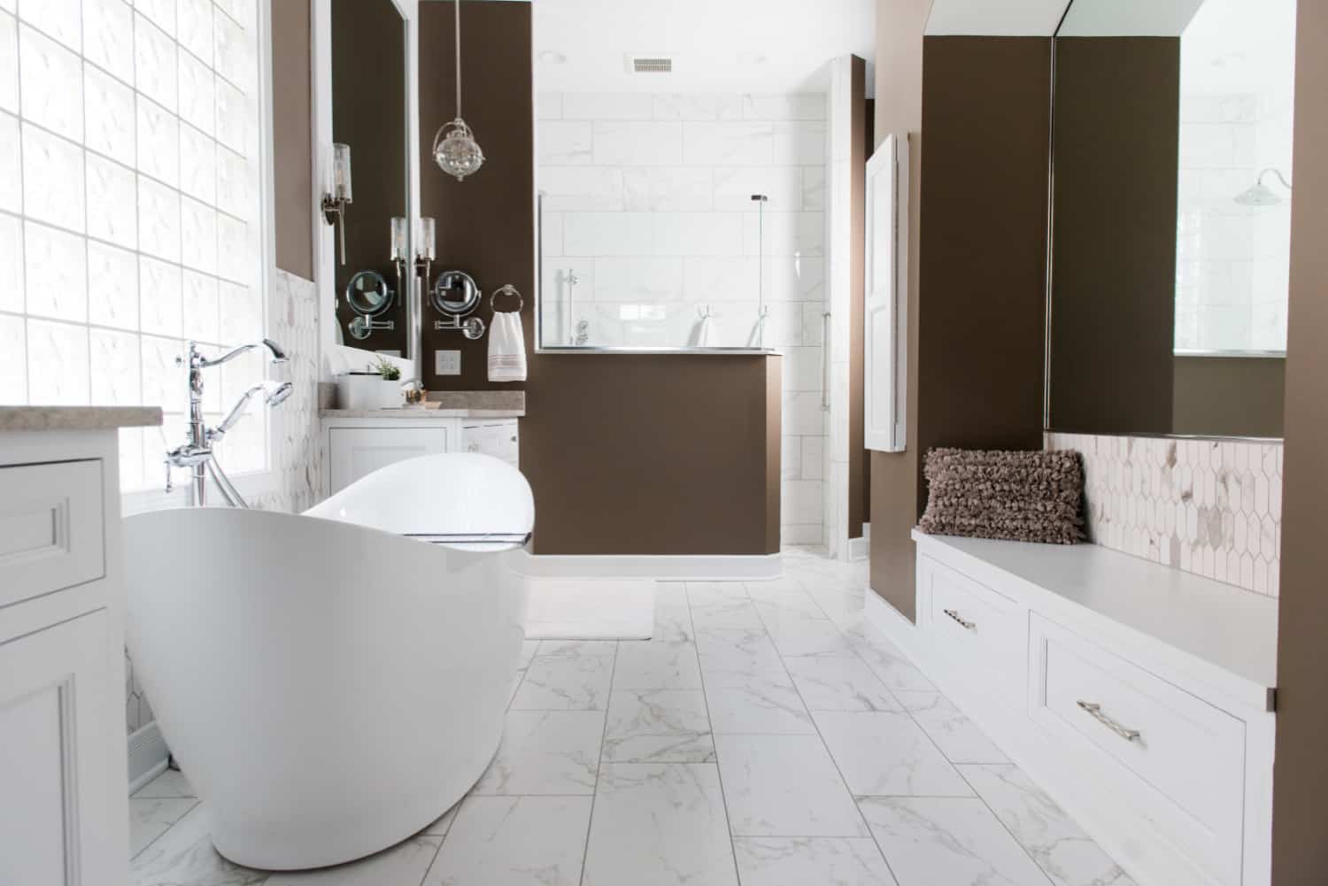 Nicholas Design Build | A white and brown bathroom oasis with a white tub.