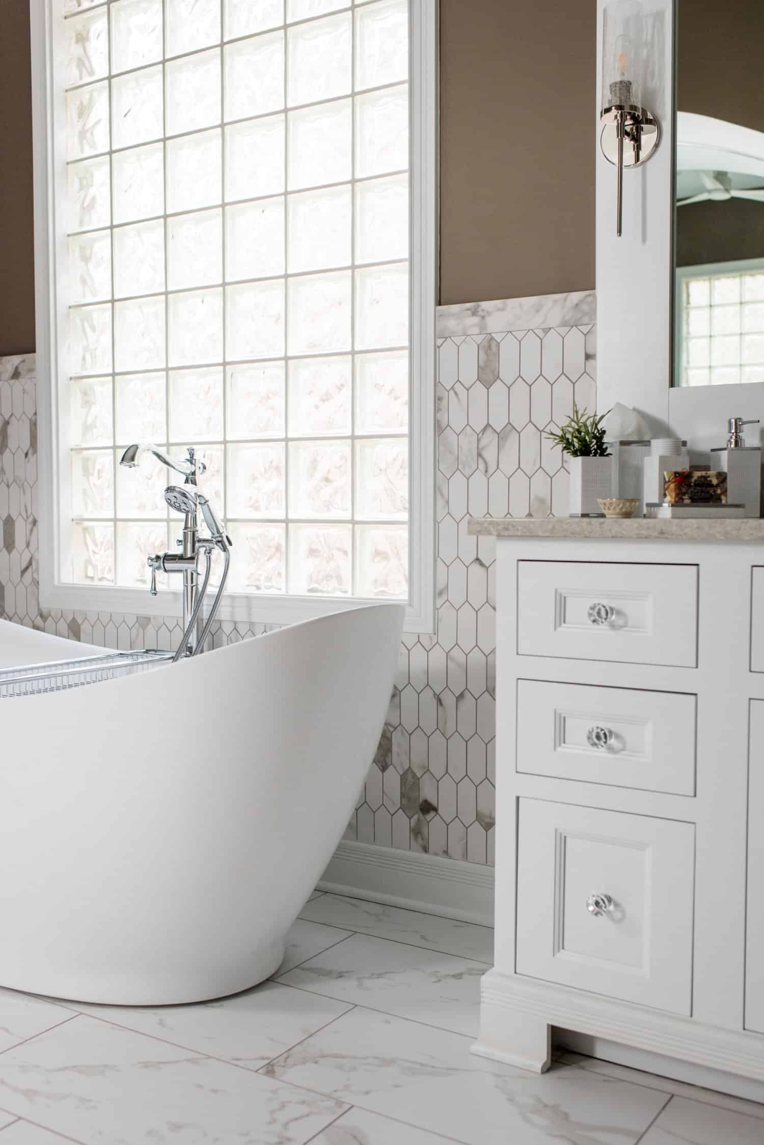 Nicholas Design Build | A white bathroom with a bathtub and sink, creating a serene oasis.