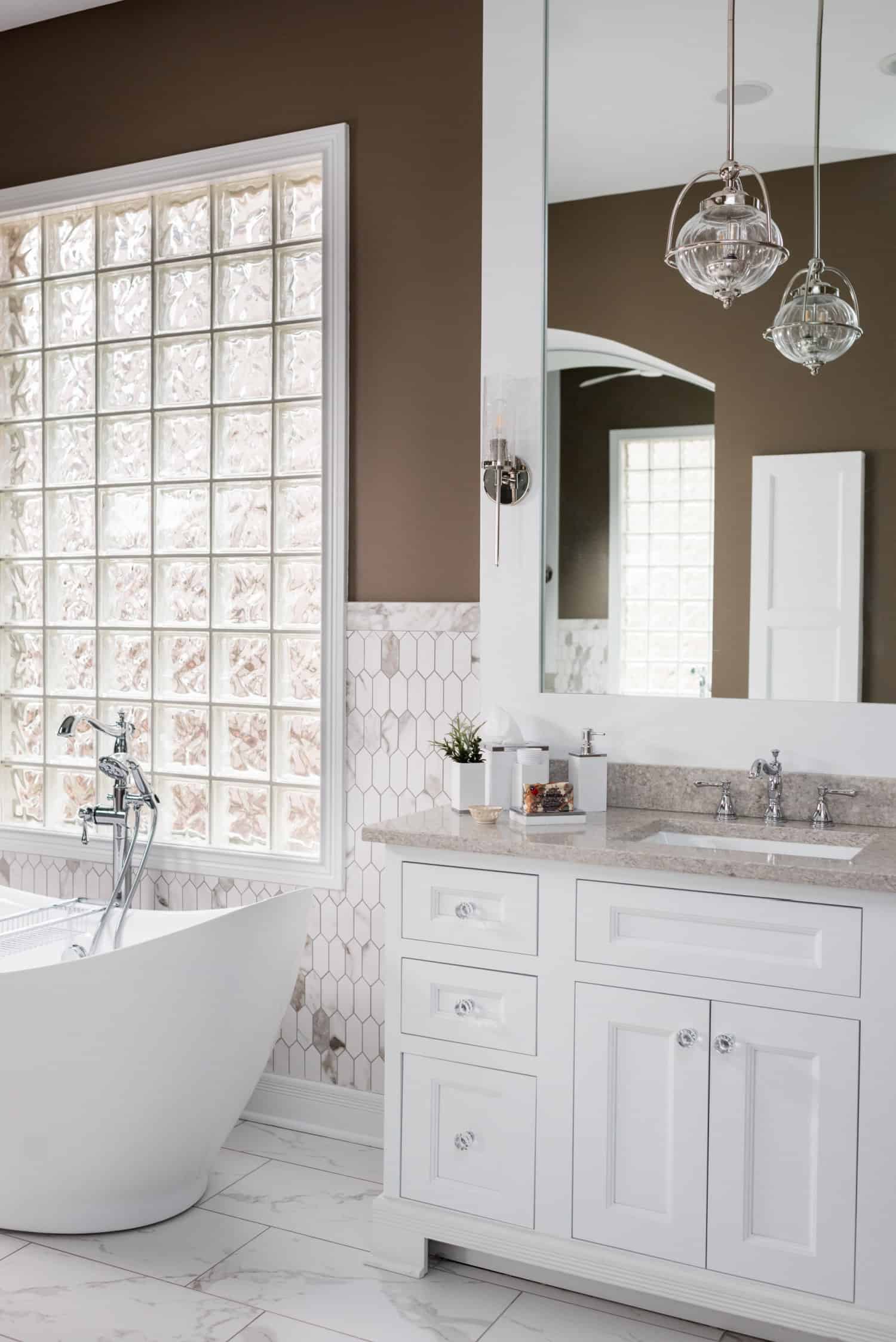 Nicholas Design Build | A bathroom oasis with a white tub and brown walls.