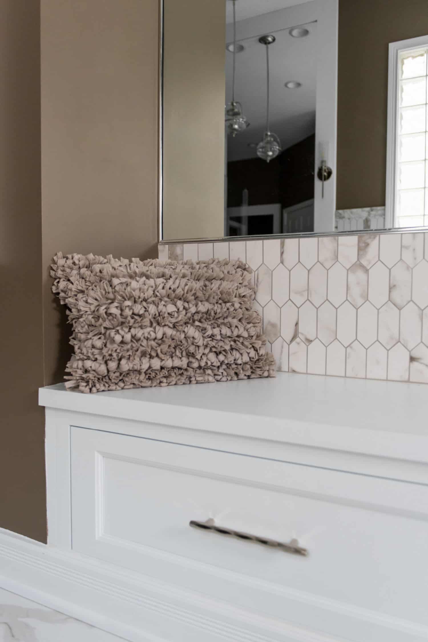 Nicholas Design Build | A white vanity in an oasis of a bathroom.
