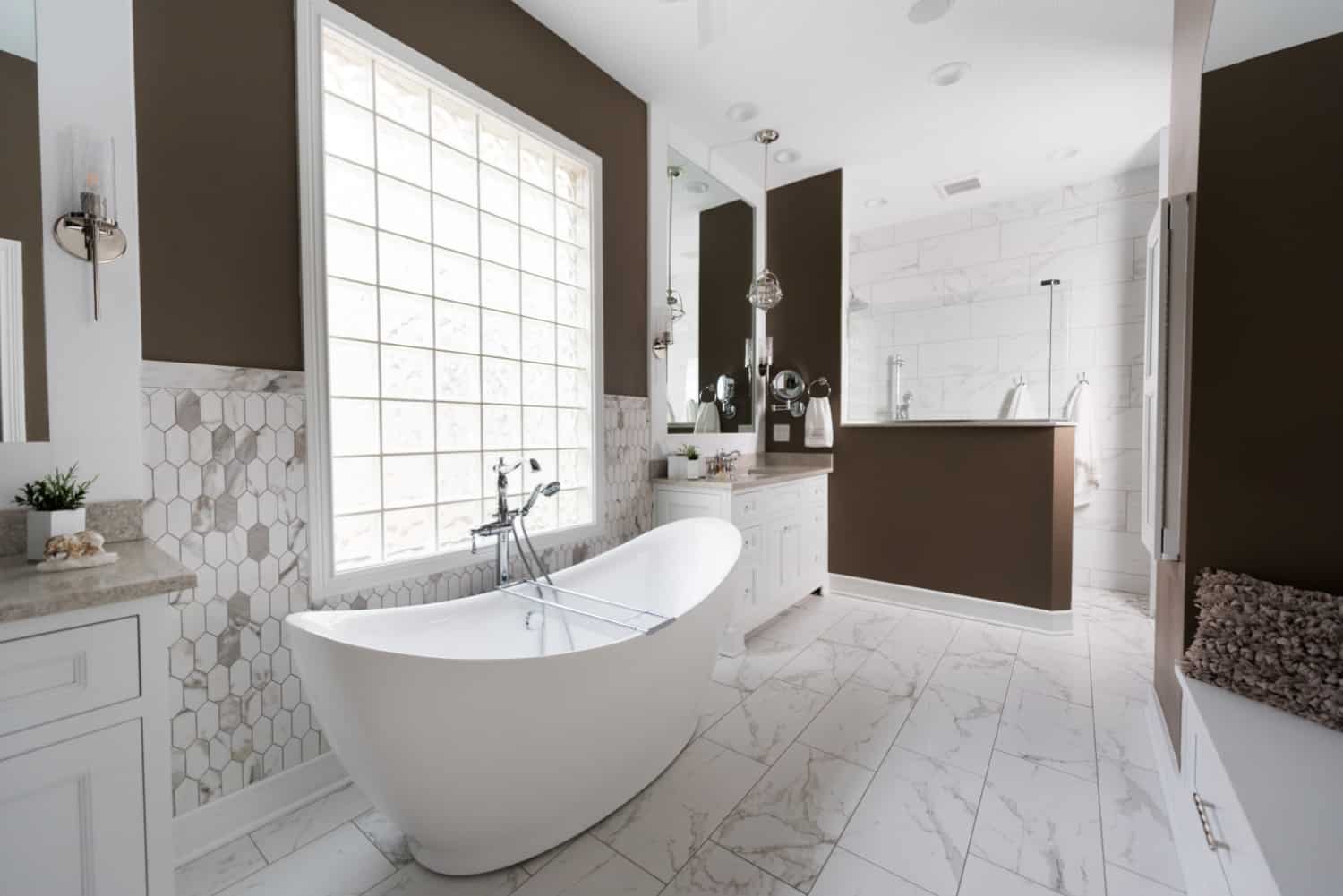 Nicholas Design Build | A white and brown bathroom with a large tub, creating an oasis-like atmosphere.
