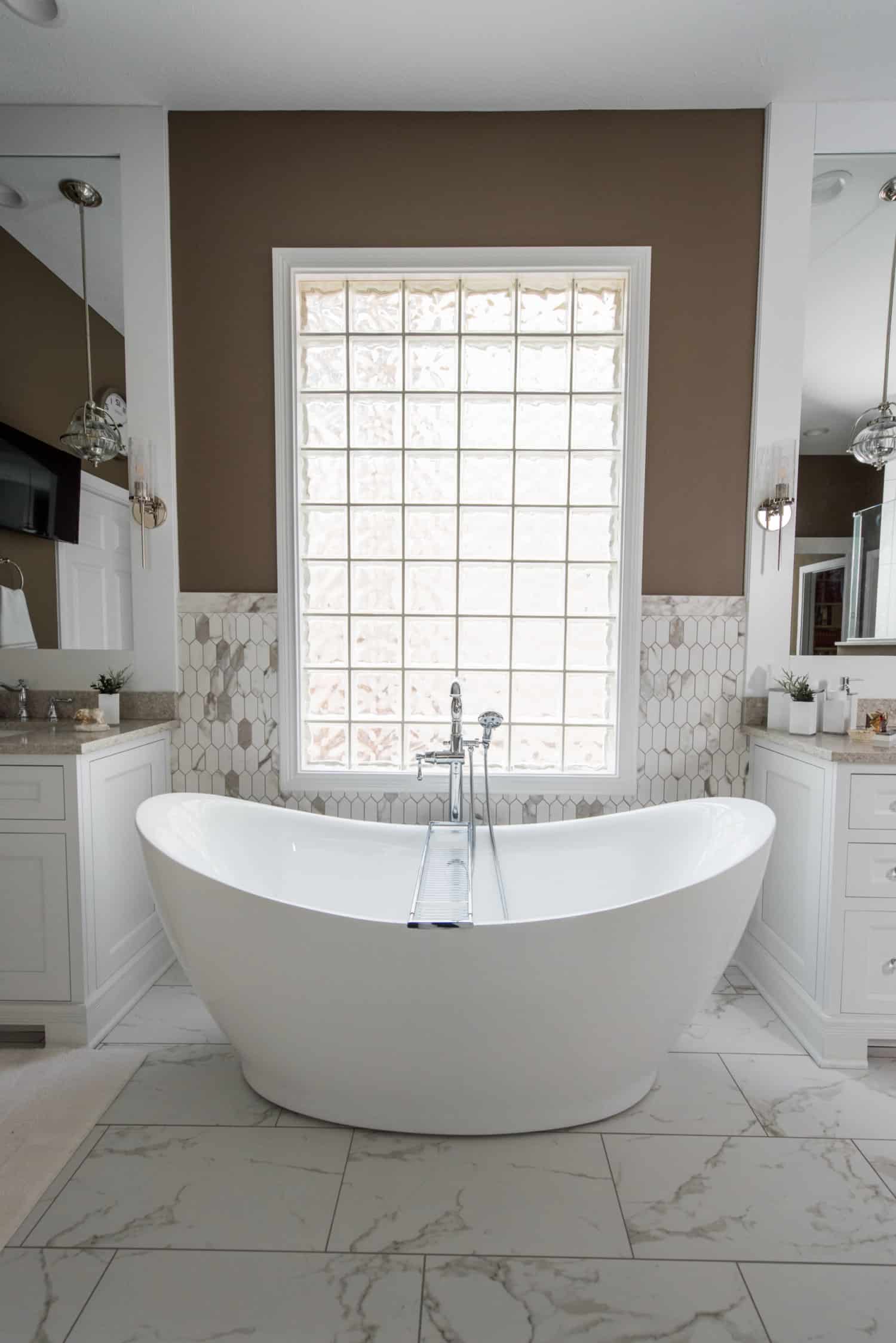 Nicholas Design Build | An oasis-like bathroom featuring a large tub and a window.