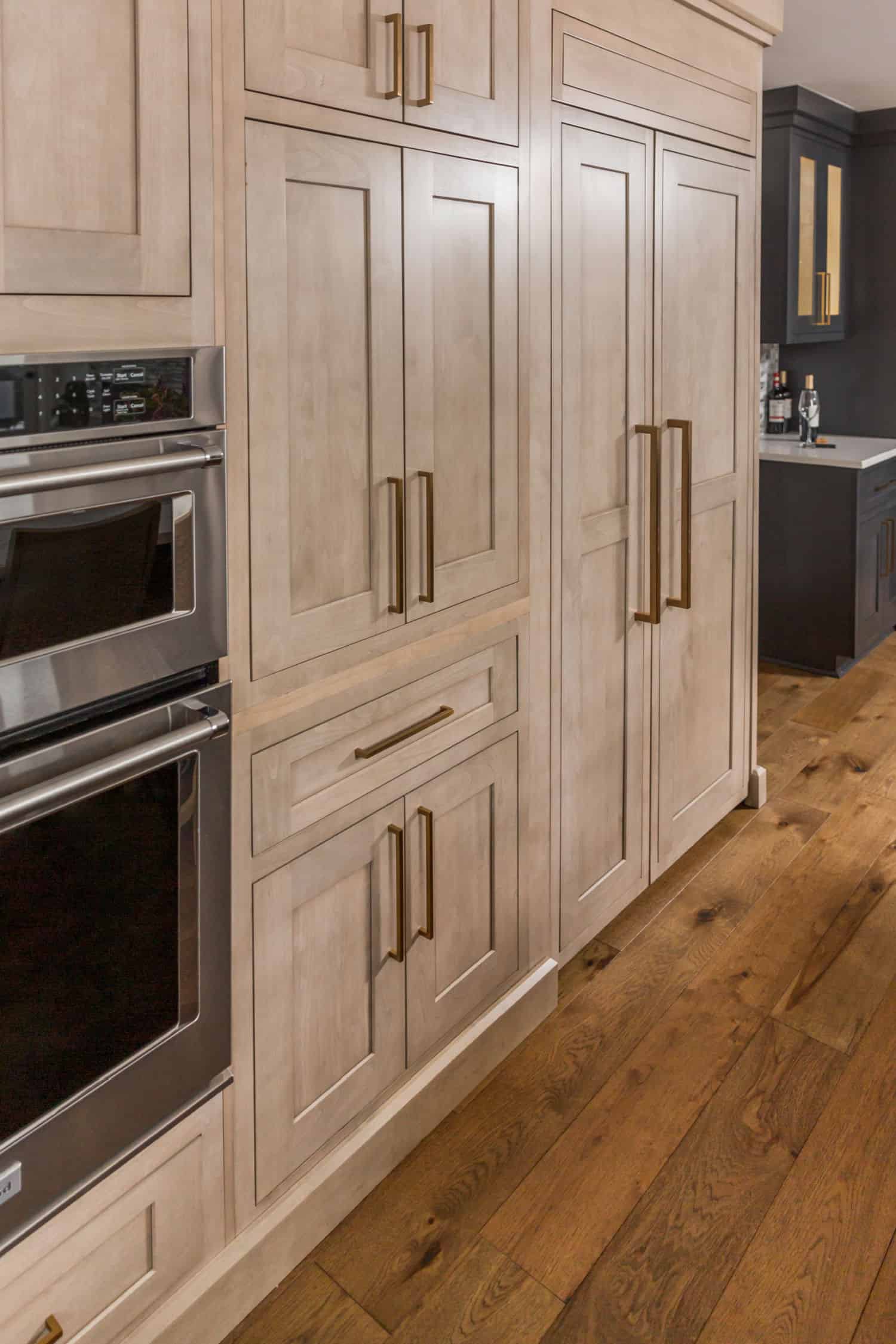 Nicholas Design Build | Remodel a kitchen with white cabinets and wood floors.