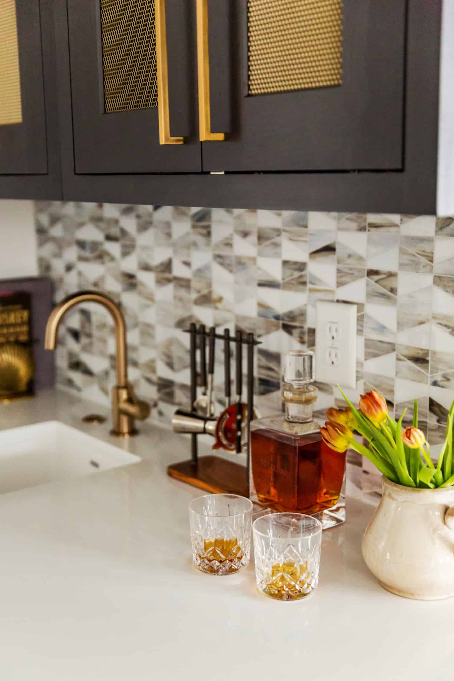 Nicholas Design Build | Remodel a kitchen with black cabinets and gold accents.
