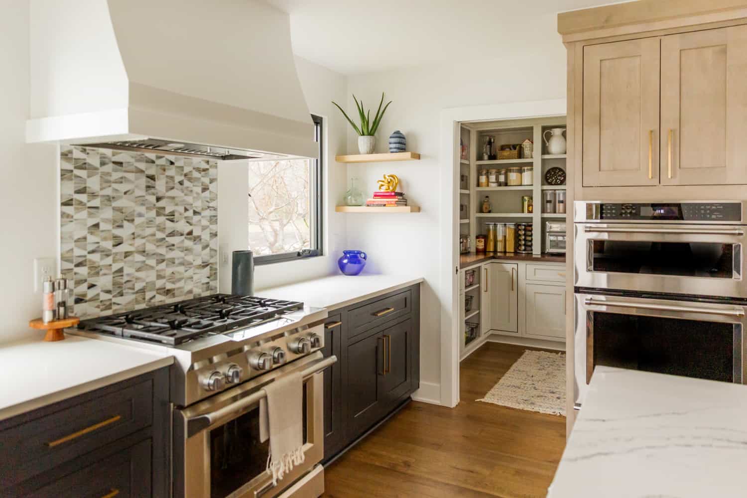 Nicholas Design Build | A remodeled kitchen with stainless steel appliances and wood cabinets.