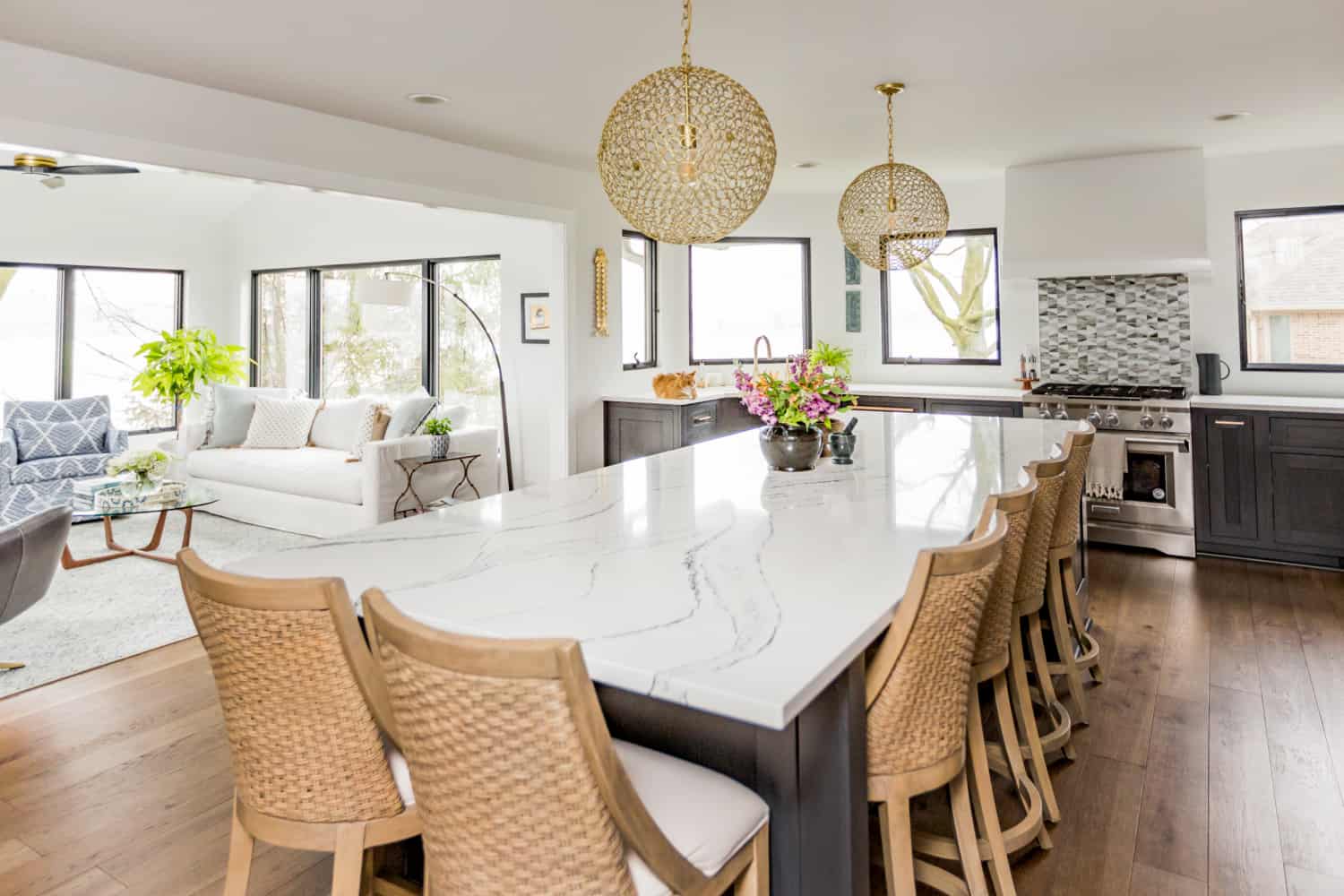 Nicholas Design Build | A remodeled kitchen with a large island and chairs.