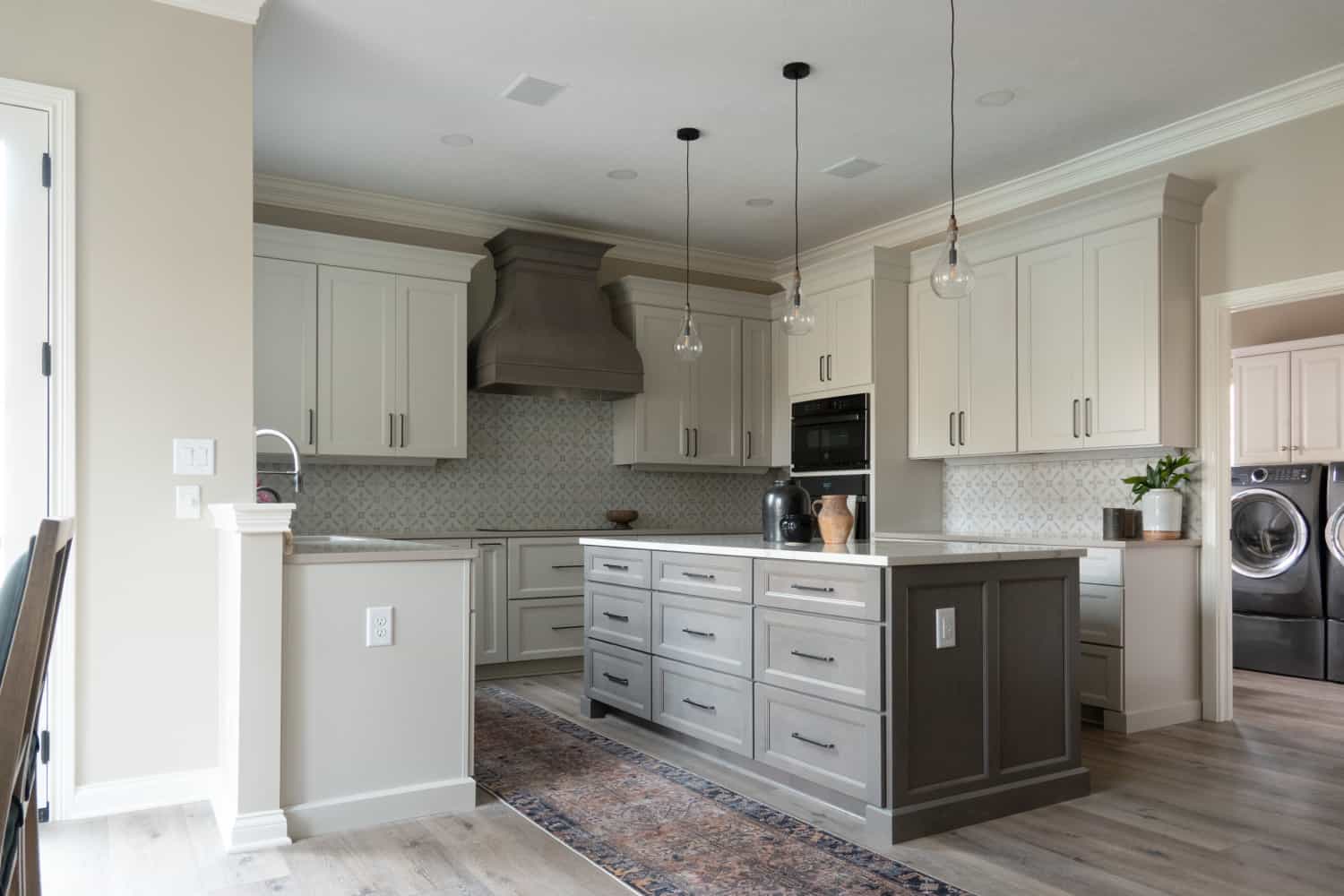 Nicholas Design Build | Remodel the kitchen with a center island and white cabinets.