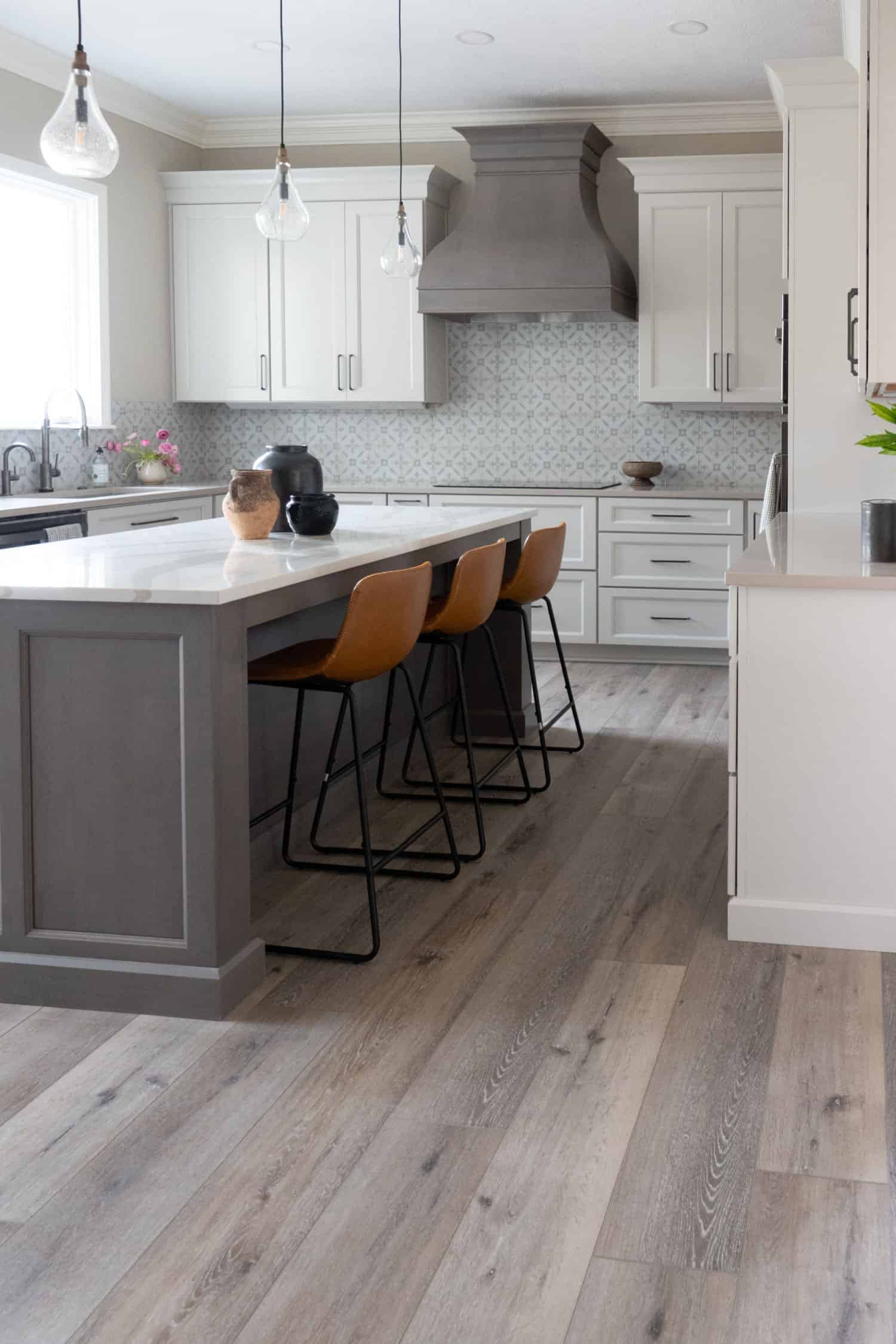 Nicholas Design Build | Remodeling a kitchen with wood floors and a center island.