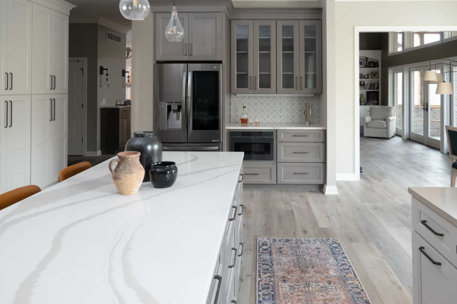 Nicholas Design Build | Remodeling a kitchen with gray cabinets and marble counter tops.