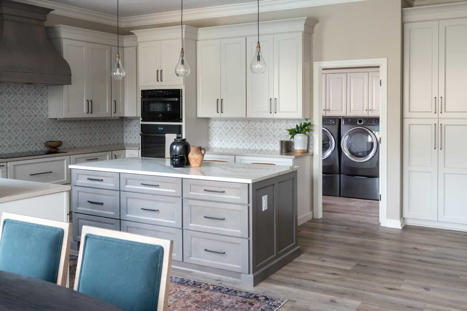 Nicholas Design Build | A remodeled kitchen with white cabinets and a center island.
