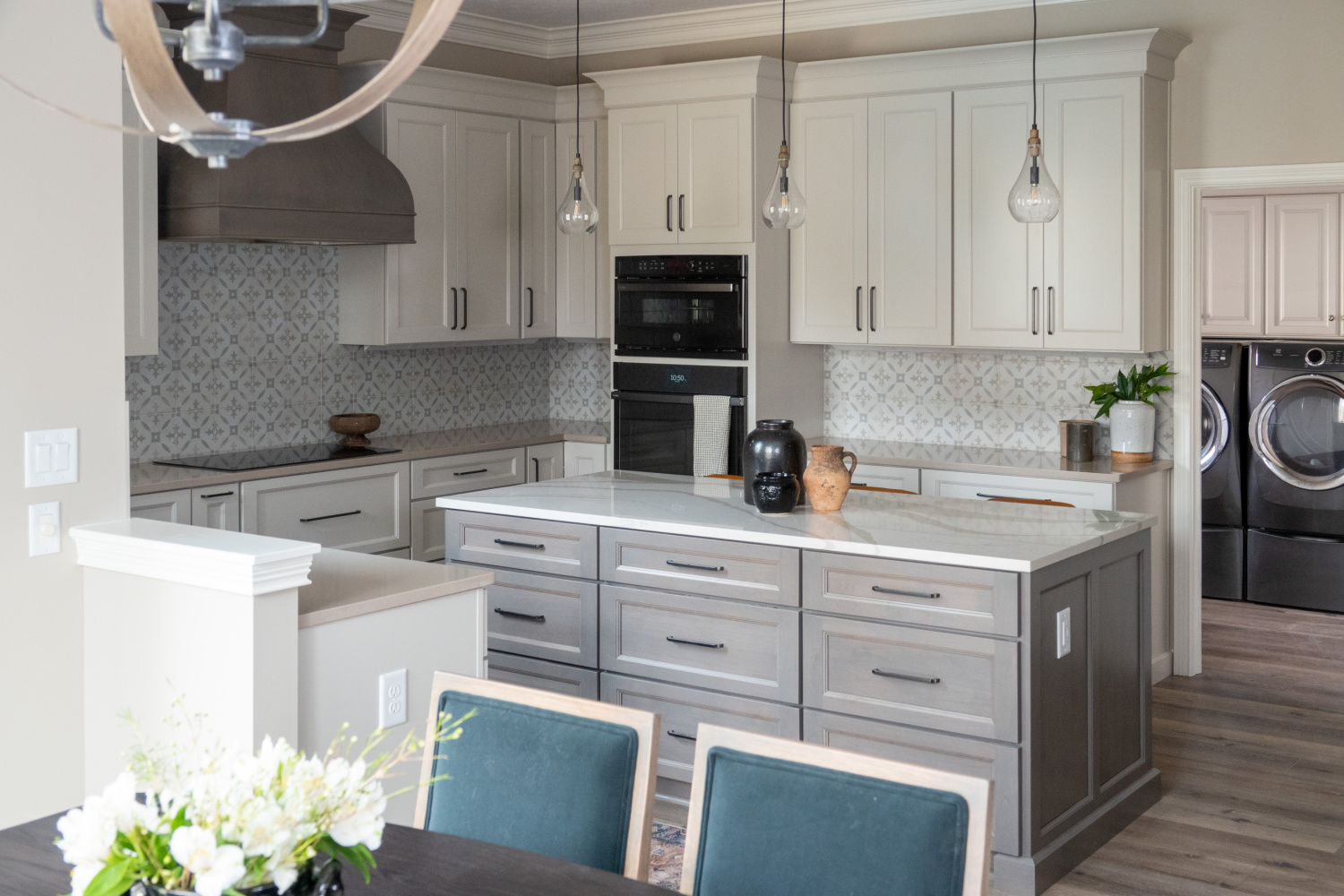 Nicholas Design Build | A remodeled kitchen with white cabinets and gray appliances.