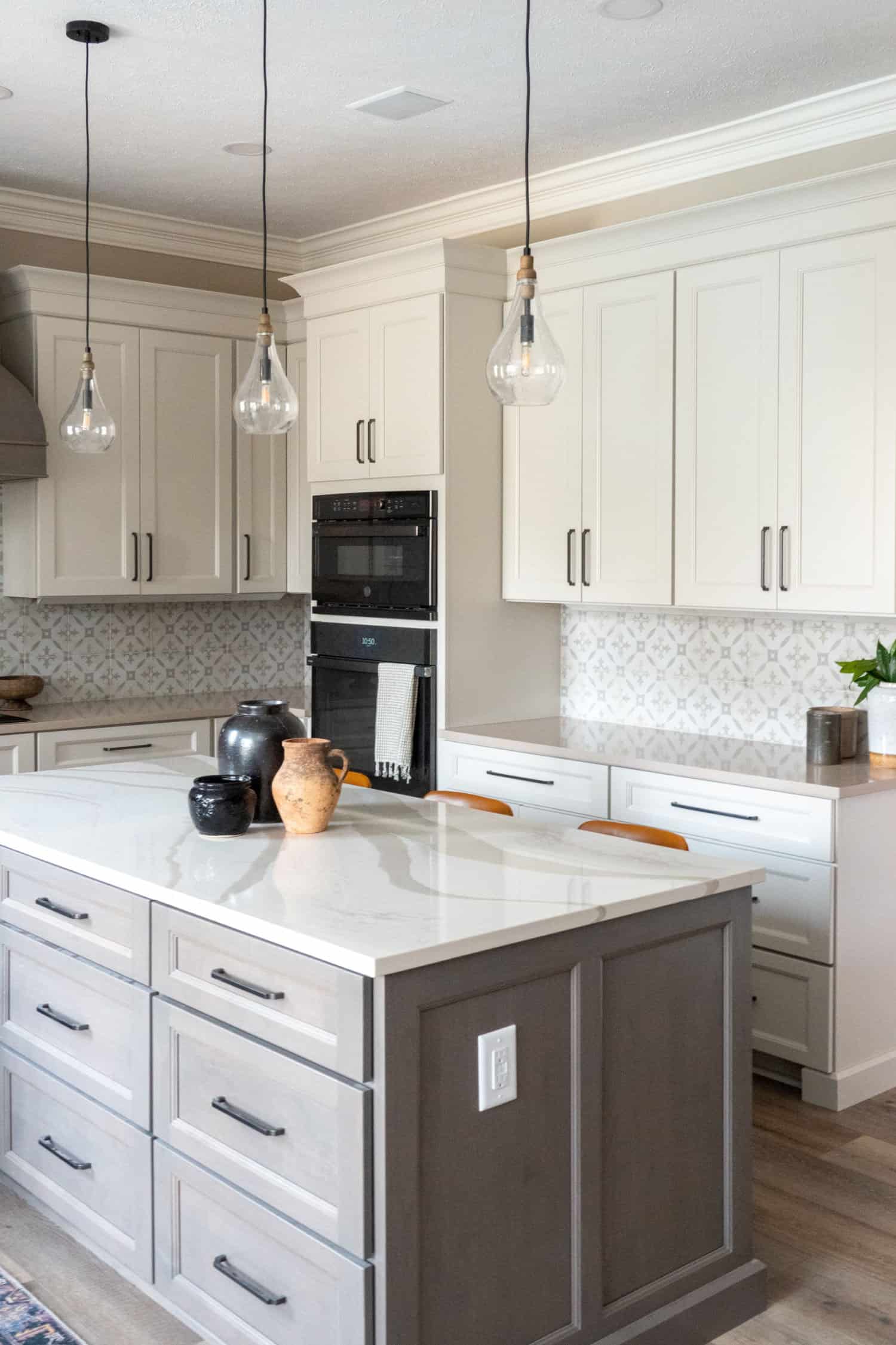 Nicholas Design Build | Remodel a kitchen with white cabinets and gray counter tops.