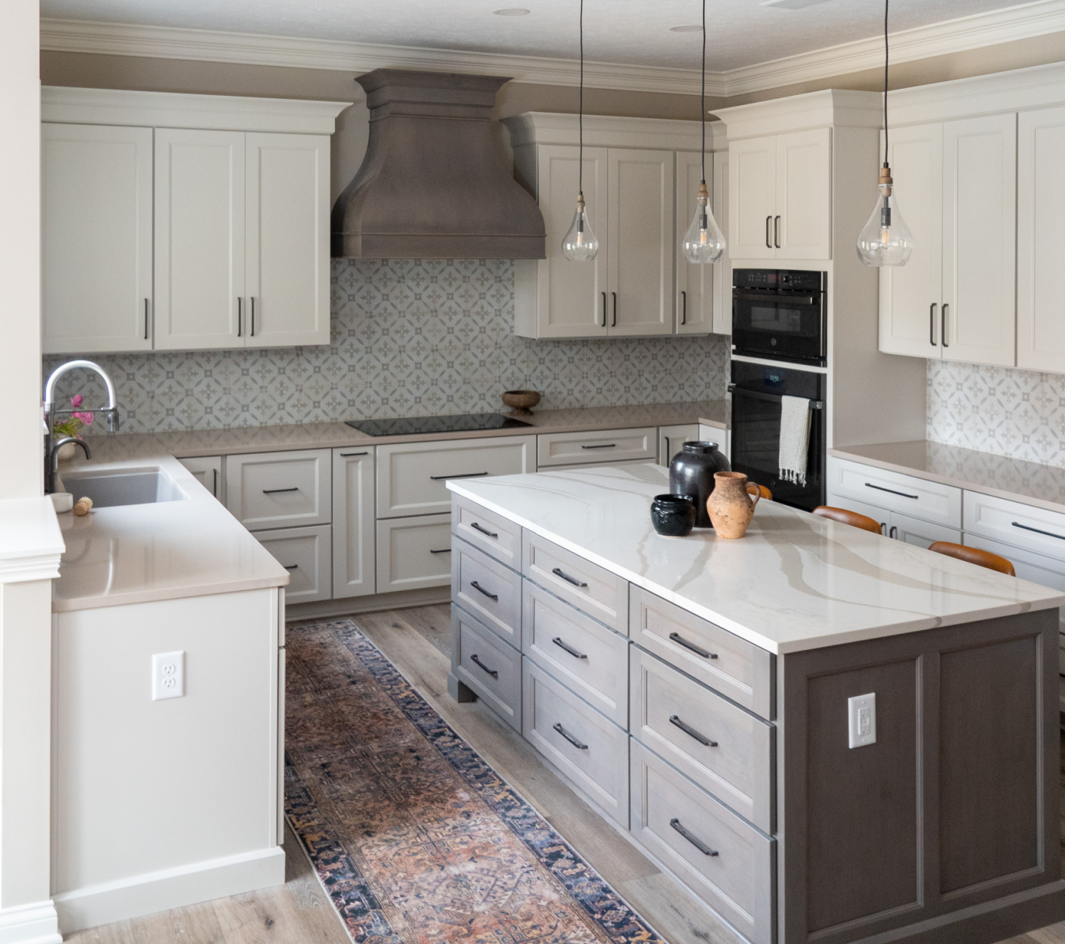 Nicholas Design Build | A kitchen remodel with white cabinets and a center island.