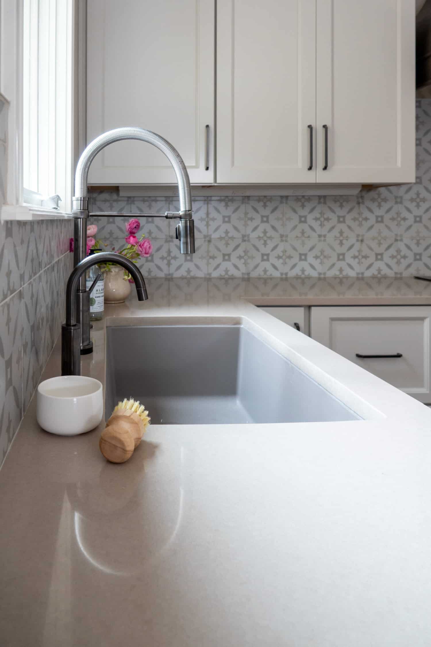 Nicholas Design Build | Remodel a kitchen with white cabinets and a white sink.