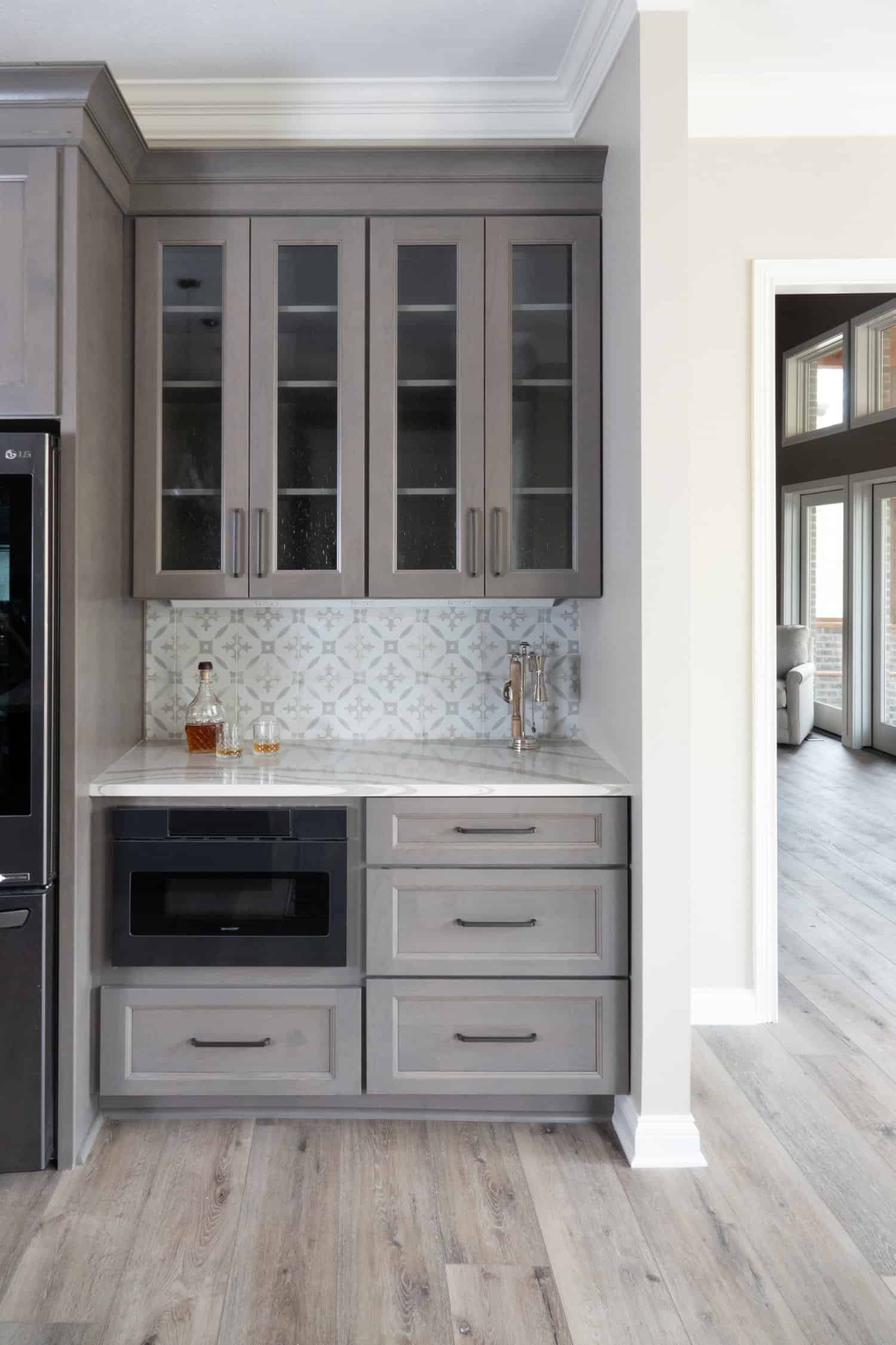 Nicholas Design Build | Remodel a kitchen with gray cabinets and black appliances.