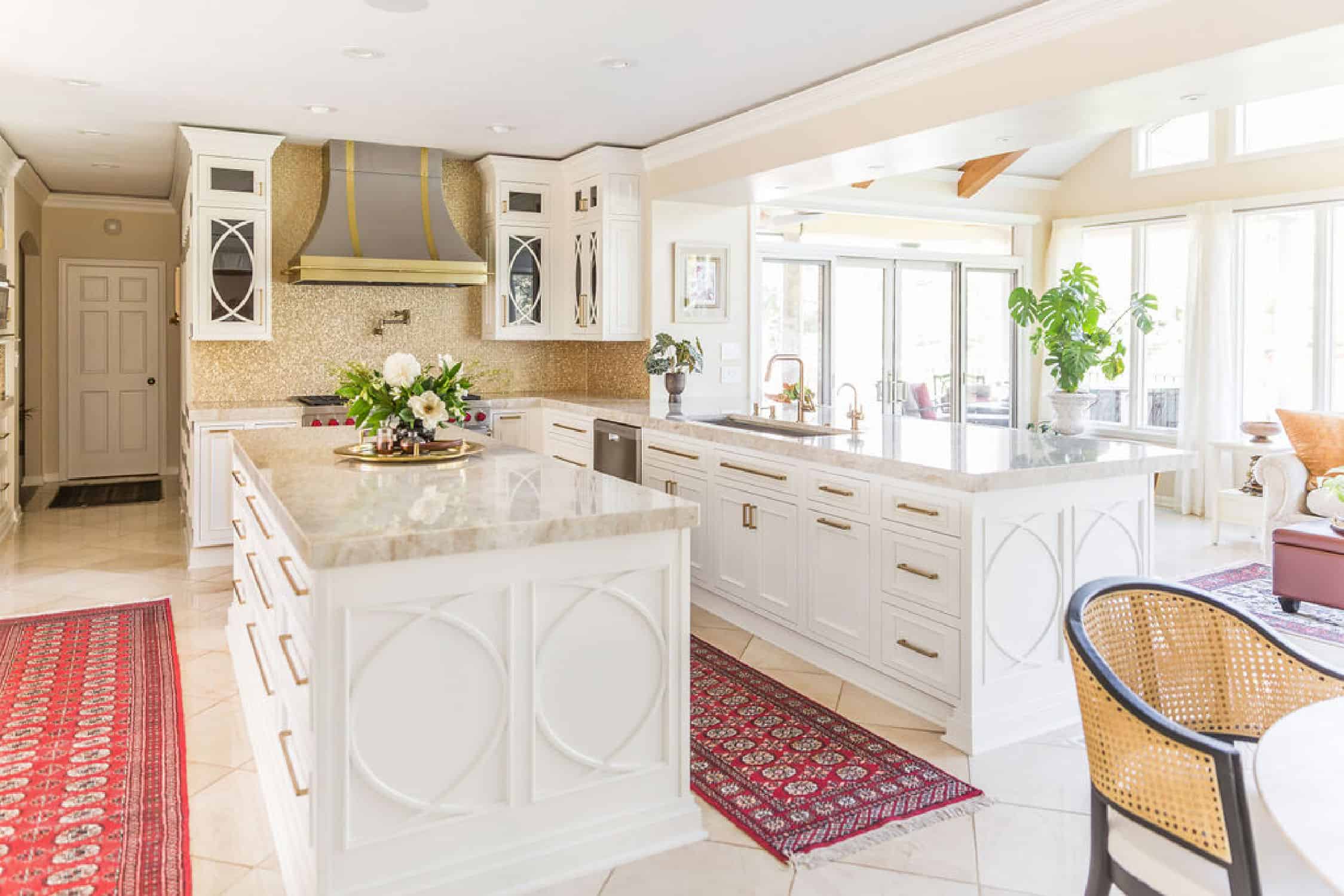 Nicholas Design Build | A remodeled white kitchen with a rug in the middle.