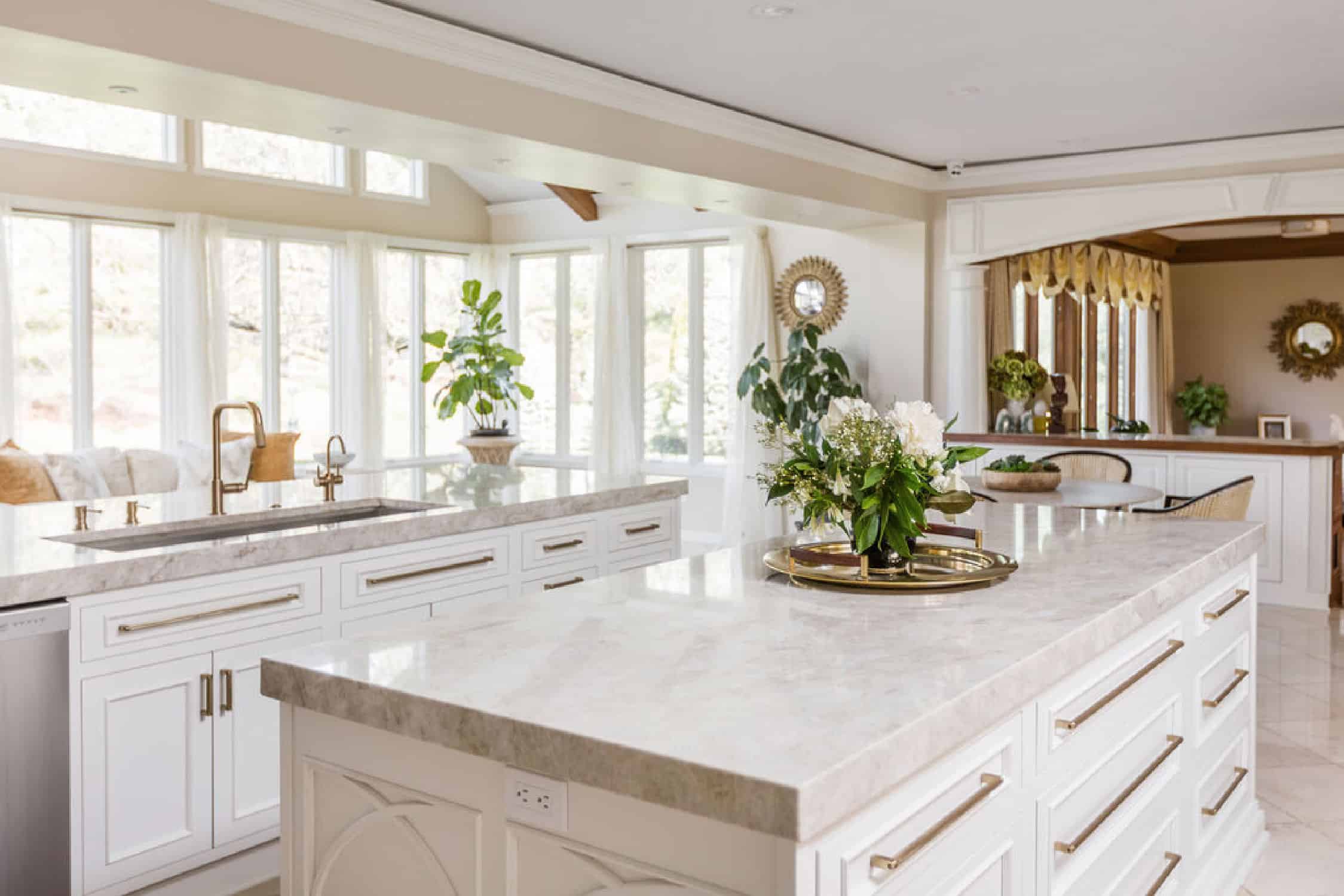 Nicholas Design Build | A white kitchen with a marble counter top undergoes a remodel.