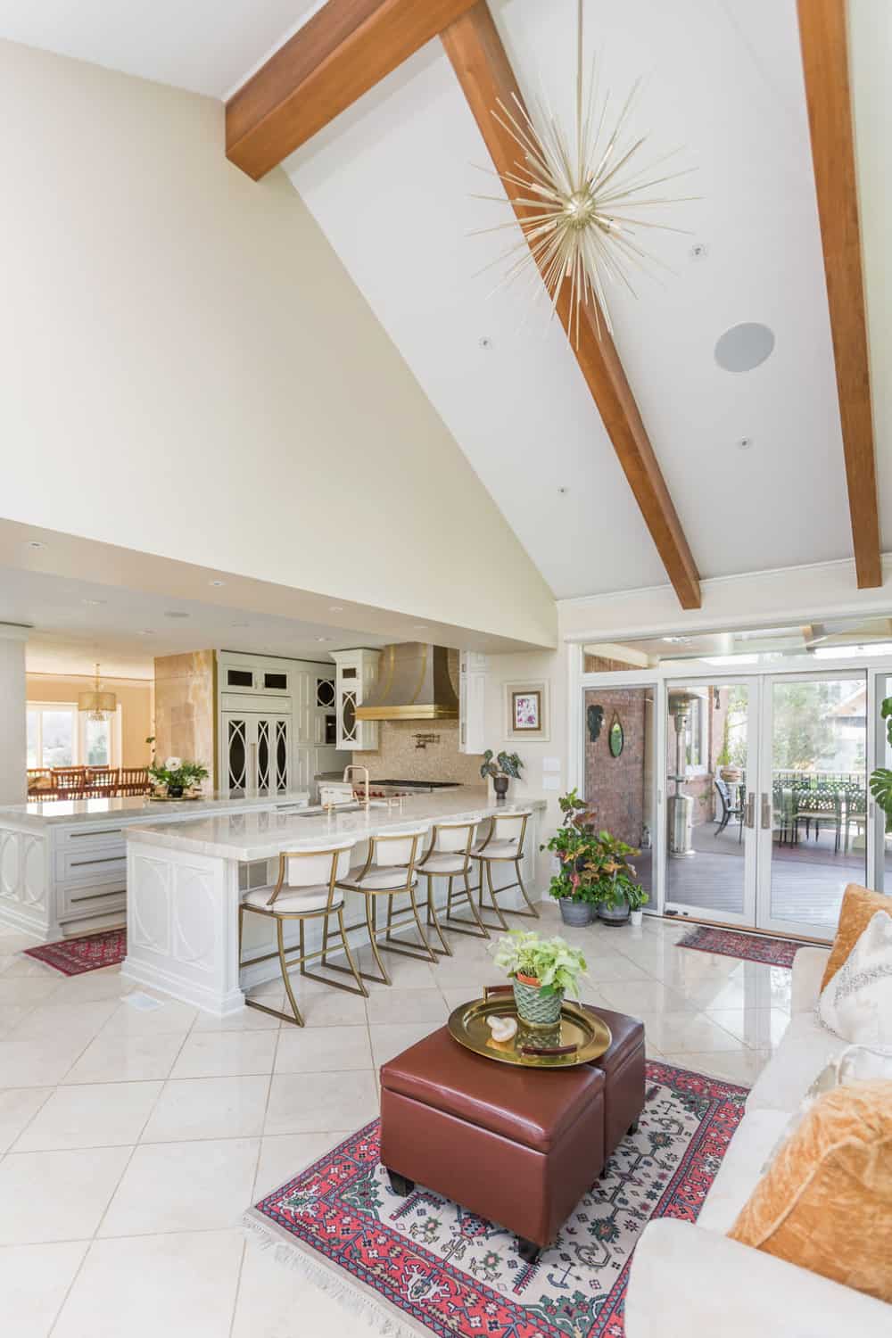 Nicholas Design Build | A large open kitchen and living room with vaulted ceilings undergoing a remodel.