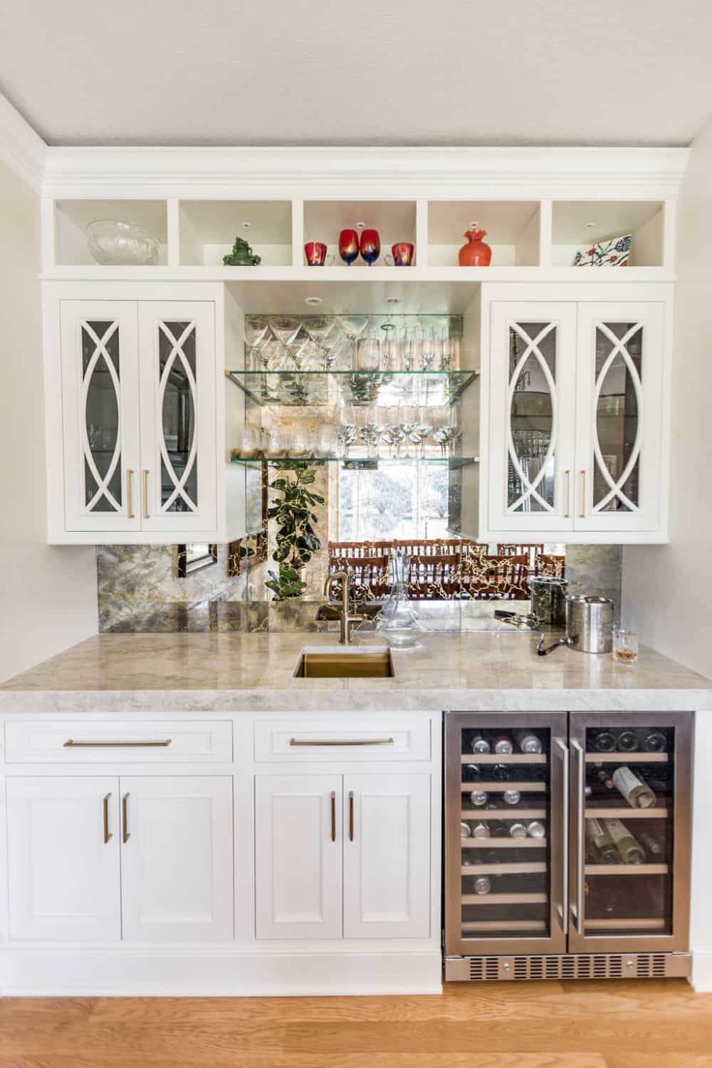 Nicholas Design Build | A recently remodeled kitchen with white cabinets and a wine rack.
