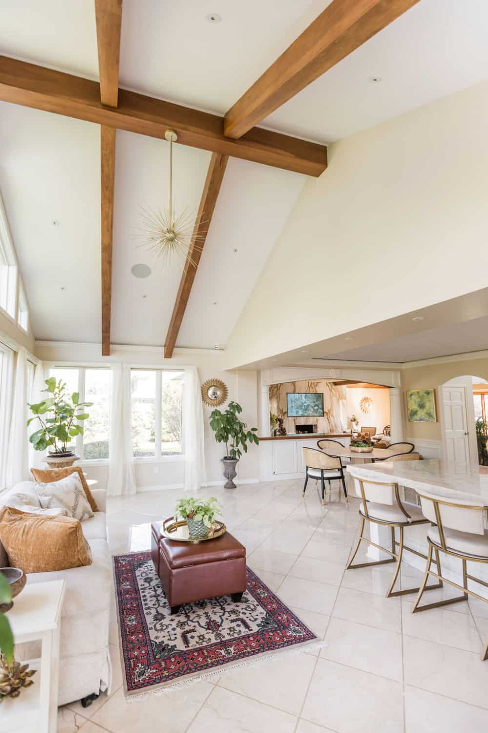 Nicholas Design Build | A large living room with wooden beams and white furniture, perfect for a remodel.
