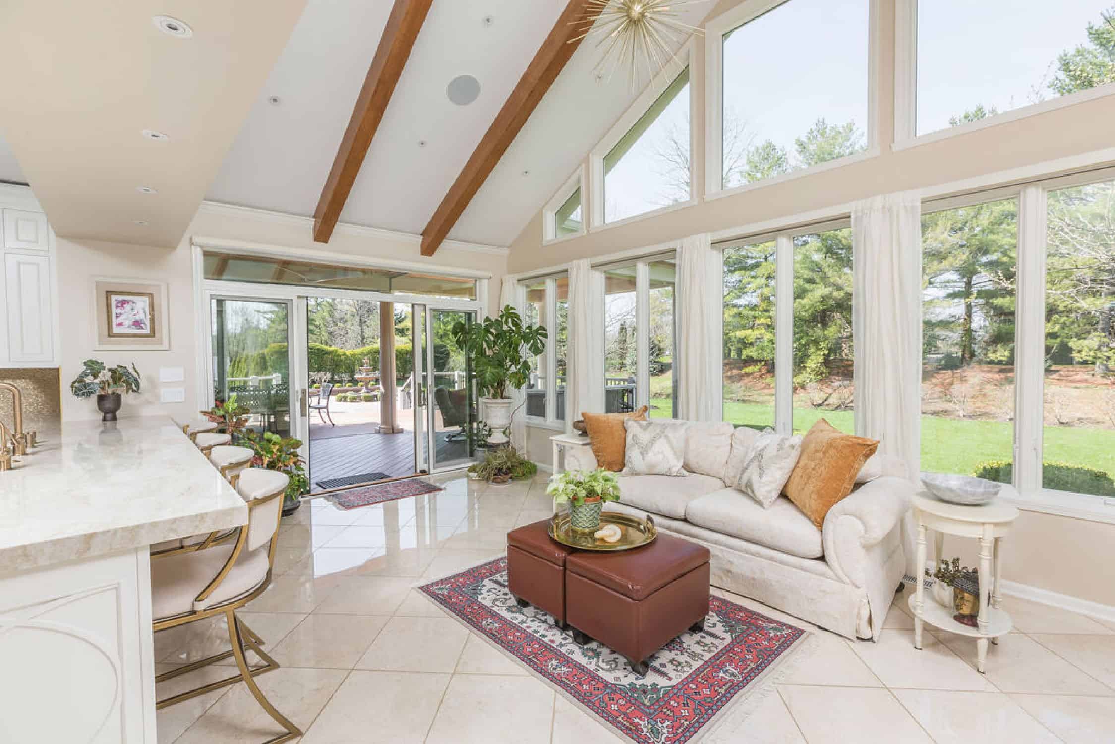 Nicholas Design Build | Remodel of a large sun room with a fireplace and large windows.