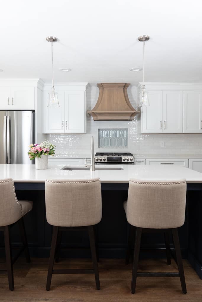 Nicholas Design Build | Remodel a kitchen with a white island and stools.