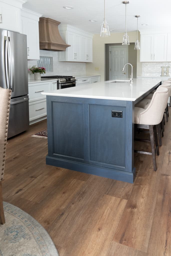 Nicholas Design Build | A remodeled kitchen with hardwood floors and a center island.