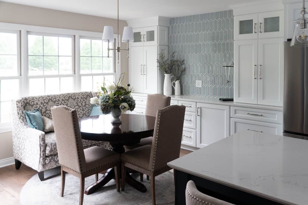 Nicholas Design Build | A remodelled white kitchen with a stunning dining table and chairs.