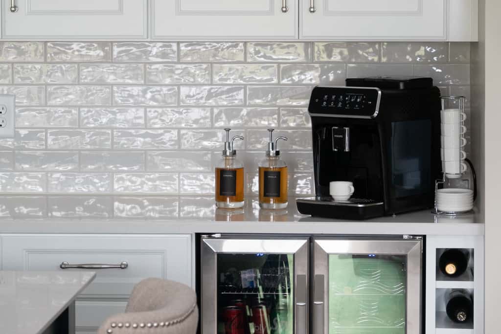 Nicholas Design Build |         Description: A remodeled kitchen with a coffee maker and a refrigerator.