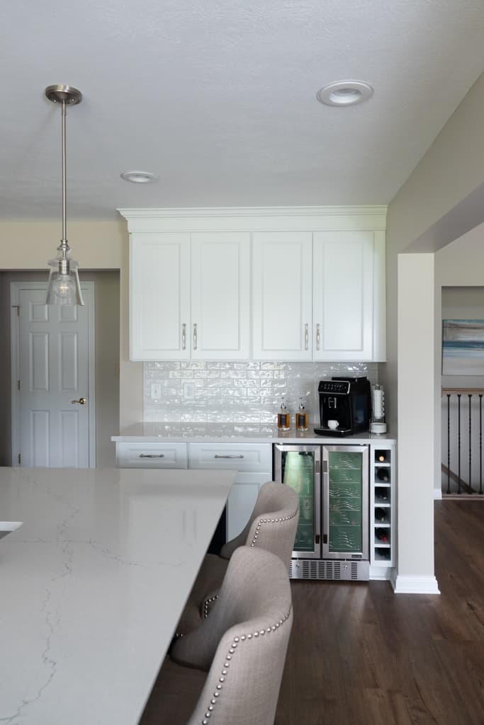 Nicholas Design Build | Remodel the kitchen with white cabinets and marble counter tops.