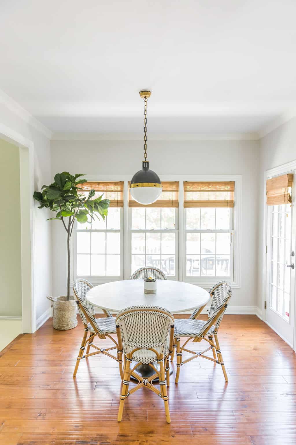 Nicholas Design Build | Remodel a dining room with a white table and chairs.