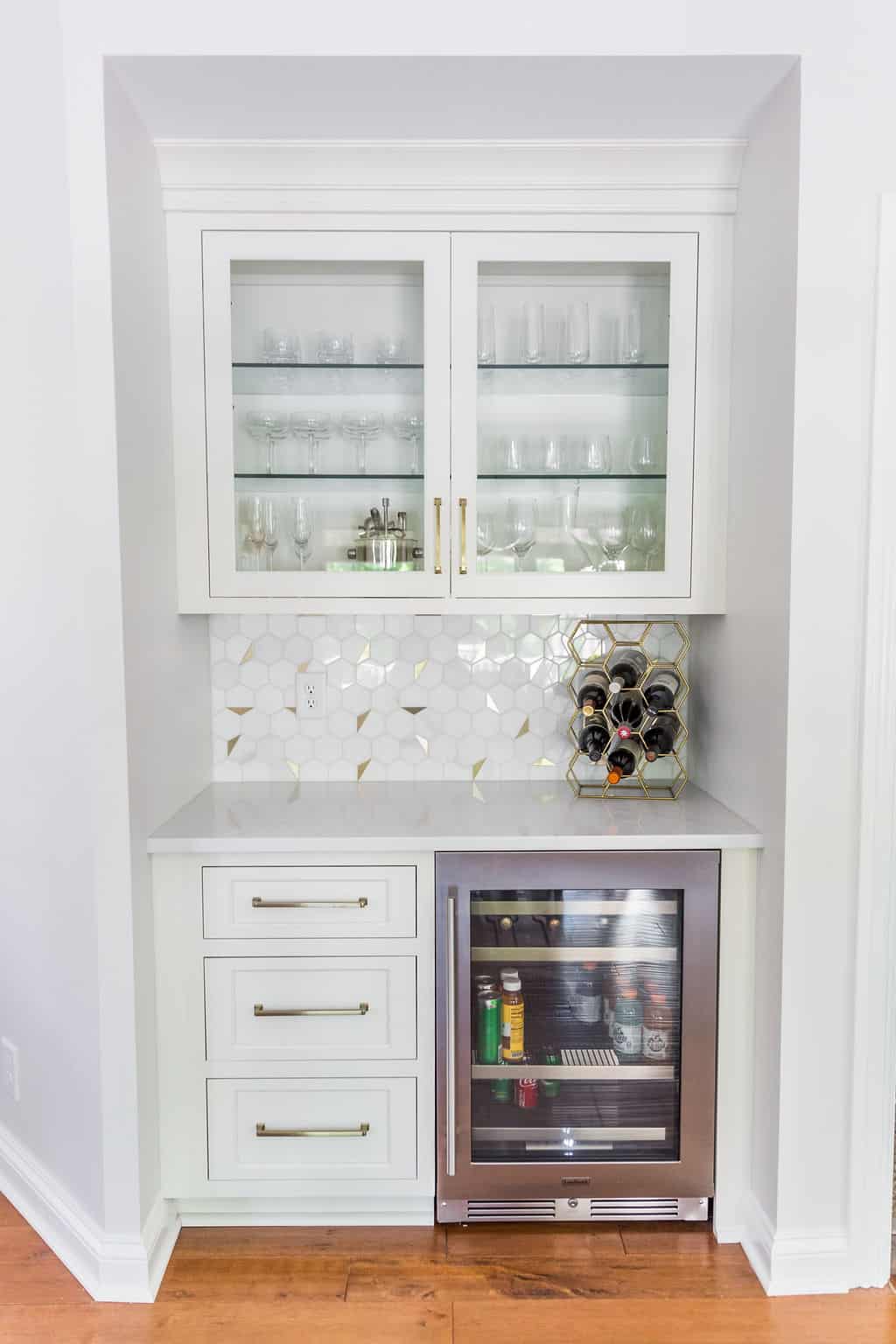 Nicholas Design Build | Remodel: A remodeled white kitchen featuring a glass door and wine cooler.