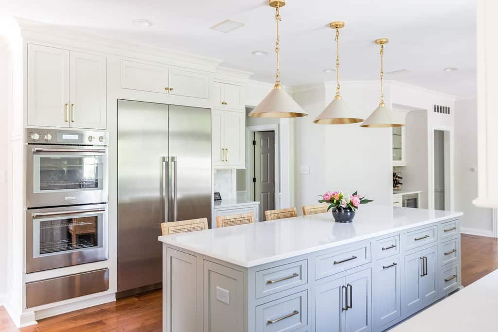 Nicholas Design Build | A remodeled kitchen with a center island and stainless steel appliances.