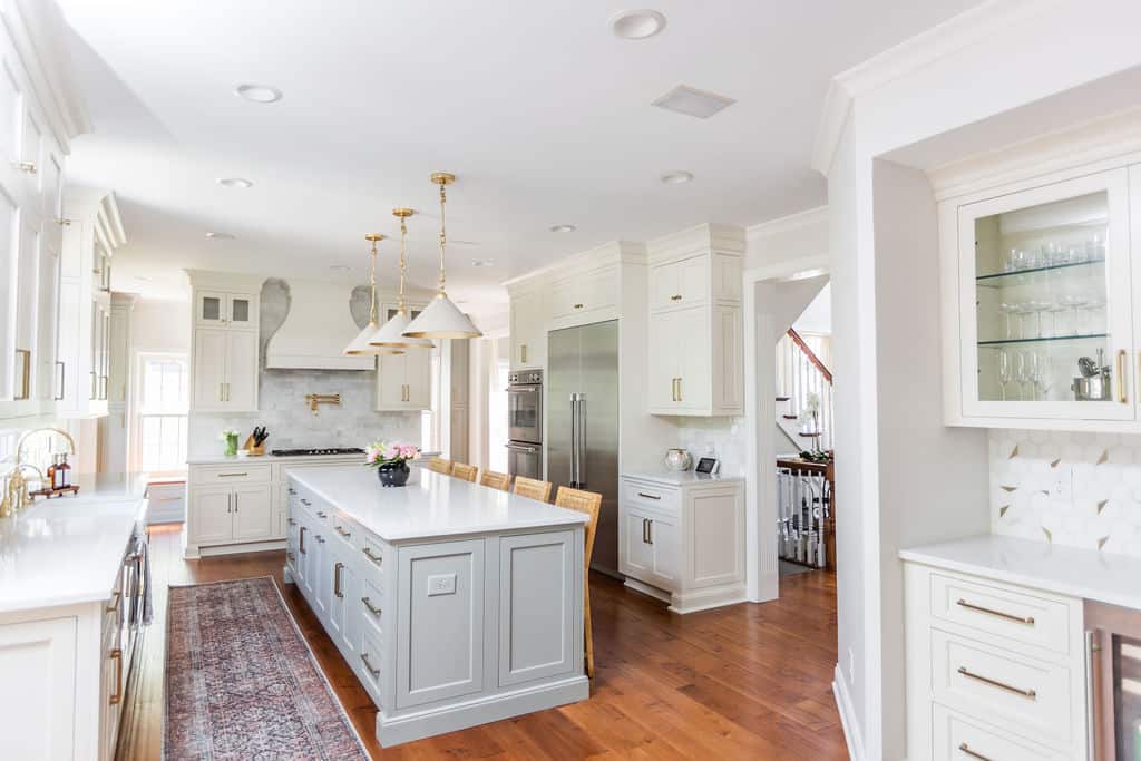 Nicholas Design Build |         Remodel the kitchen with a large island and white cabinets.