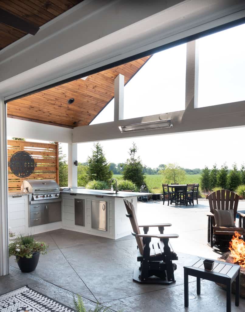 Nicholas Design Build | A remodel of an outdoor kitchen and dining area with a fireplace.