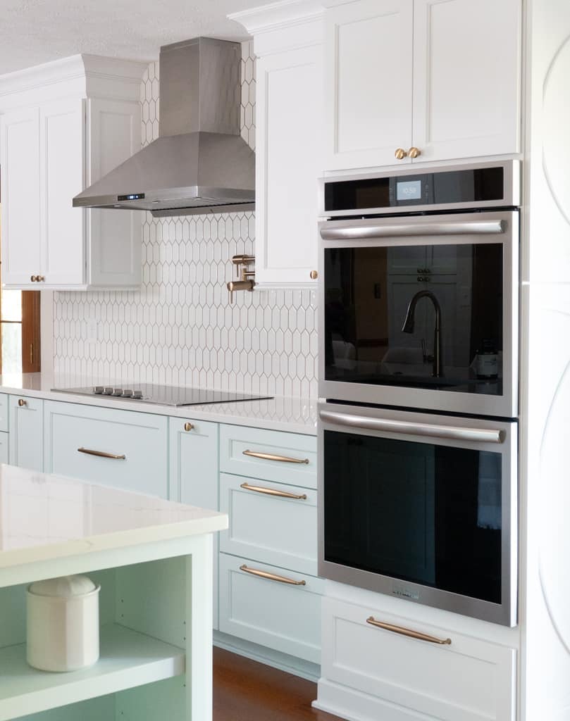Nicholas Design Build | A remodeled kitchen with light blue cabinets and white appliances.