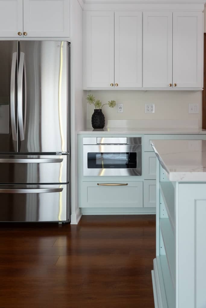 Nicholas Design Build | Remodeling a kitchen with white cabinets and stainless steel appliances.